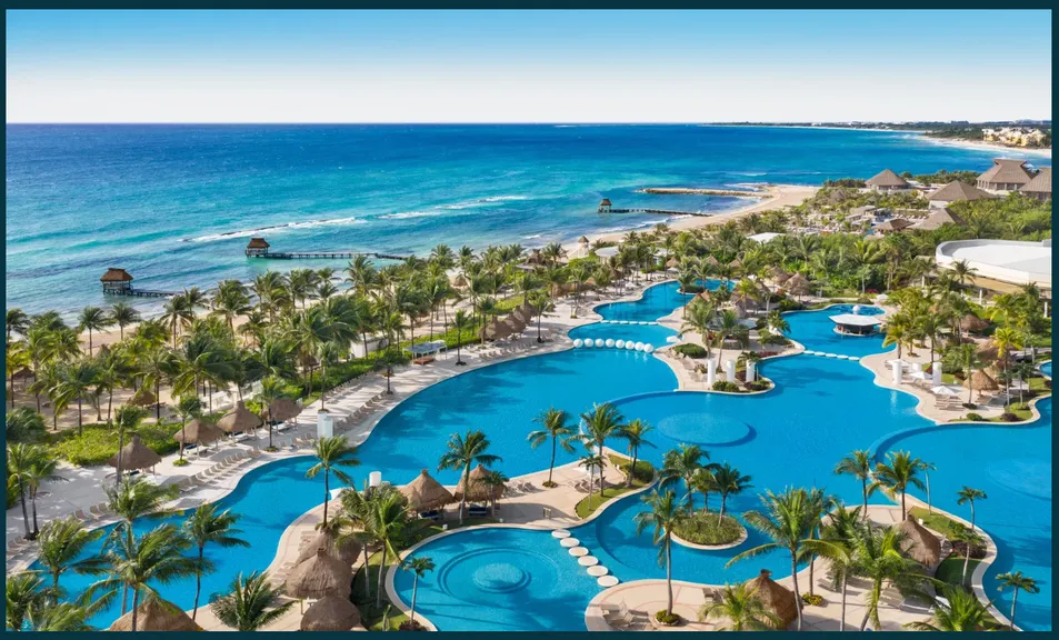 Aerial view of a coastal Mexican resort and pools