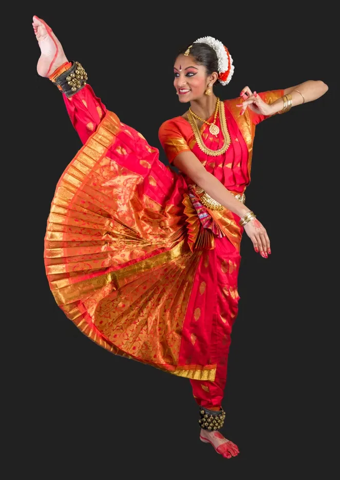 Sainrithya dancer in a vivid red and gold costume